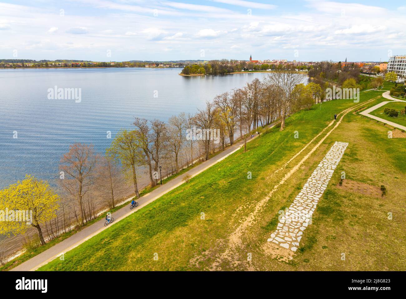 Elk, Poland - May 1, 2022: Panoramic aerial view of Jezioro Elckie lake strait with city beach peninsula and wooded shores in Elk town in Masuria Stock Photo
