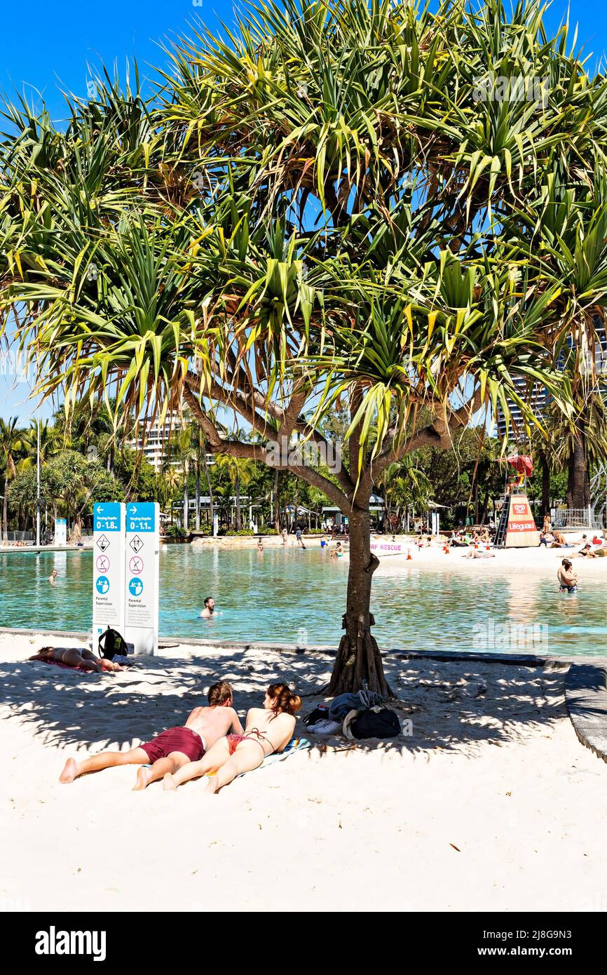 Brisbane Australia / A young couple enjoy the sunshine at Streets Beach