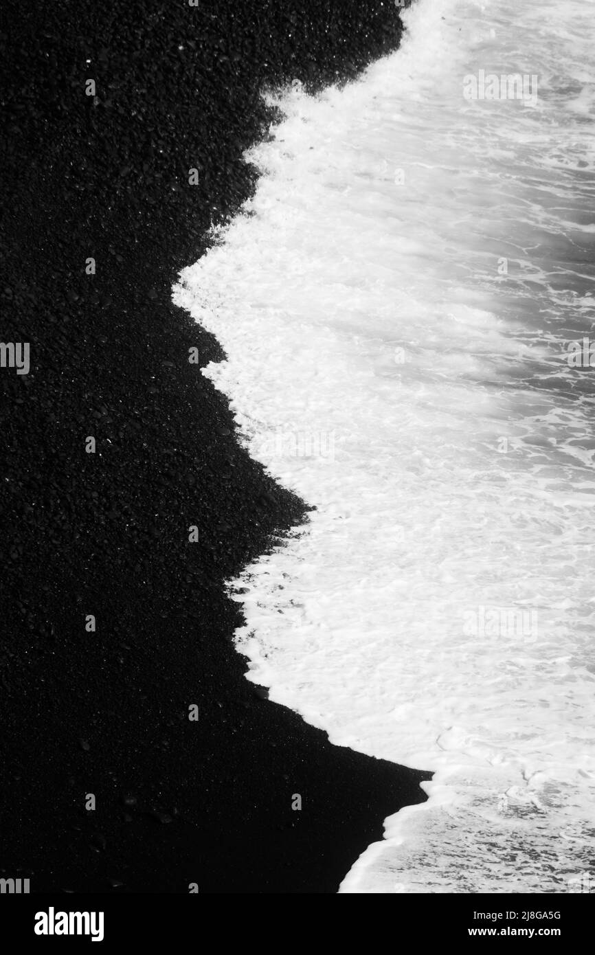 High contrast view of the ocean tide on the black volcanic beach of Lanzarote, Spain Stock Photo