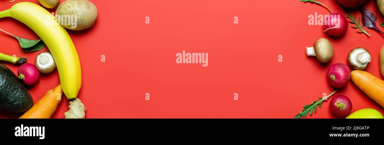 Top view of fresh fruits and vegetables on red background, banner Stock ...