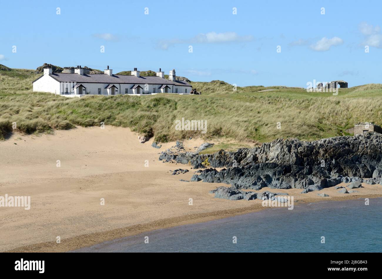 Row of old keepers pilots cottages on Ynys Llanddwyn islans Anglesey Ynys  Mon Wales Cymru UK Stock Photo