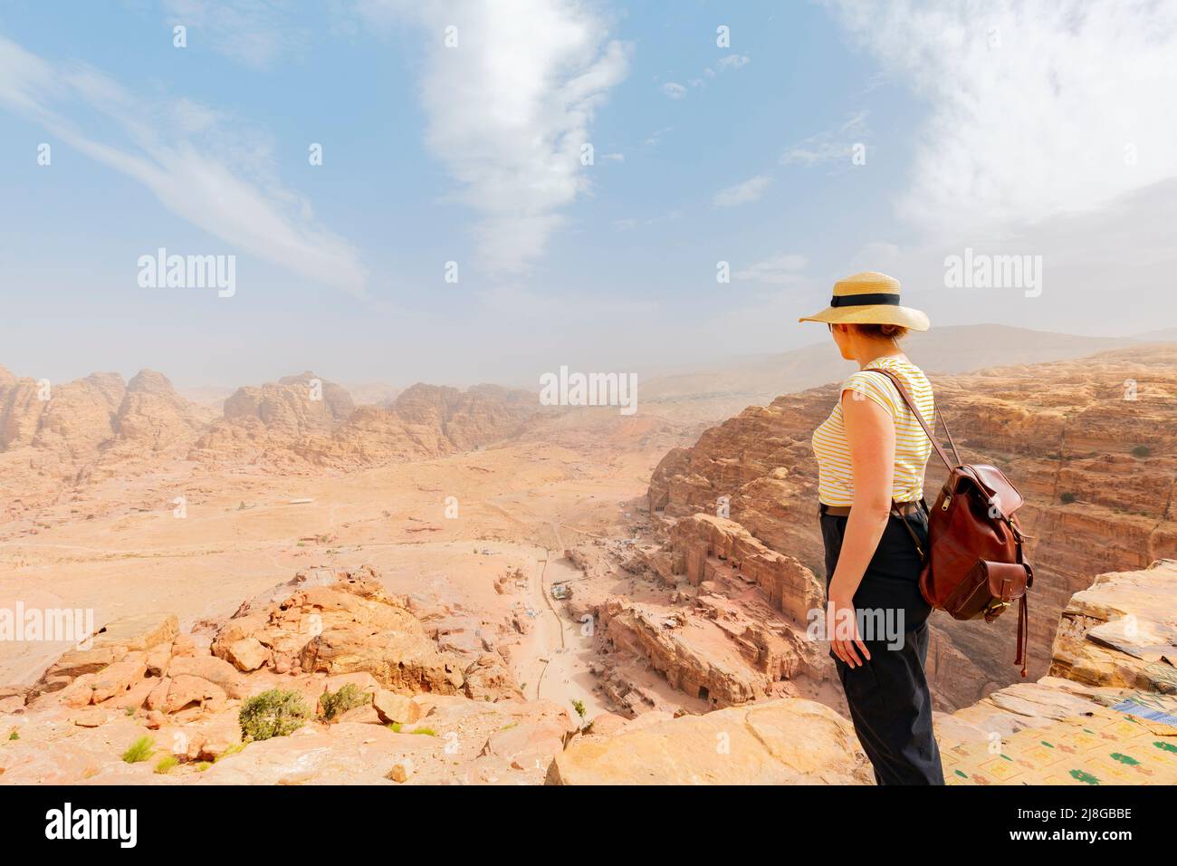 Tourist looks at the red rocky mountains in Petra. Jordan Stock Photo