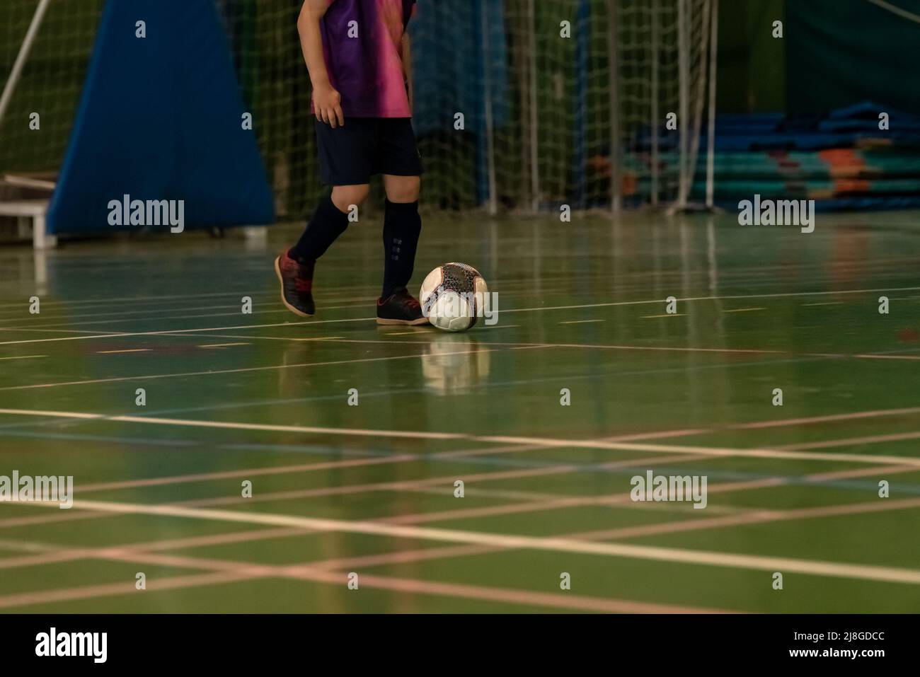 children indoor football player prepares to kick off from the centre of the pitch in spain Stock Photo