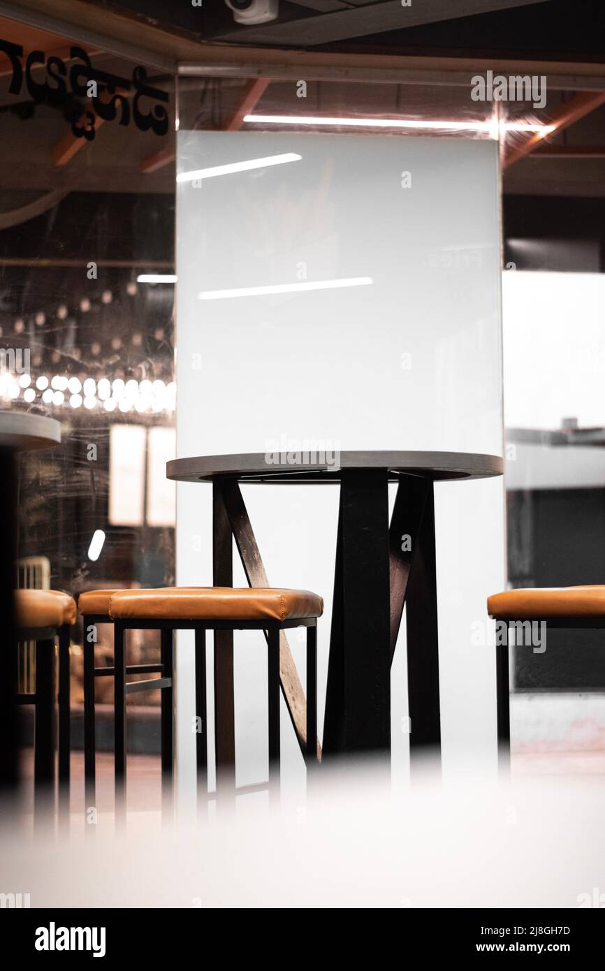 A picture of an empty table and chair in a not so busy restaurant Stock Photo