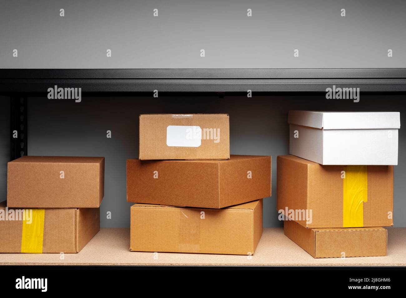 Rows of shelves with cardboard boxes in modern warehouse Stock Photo ...