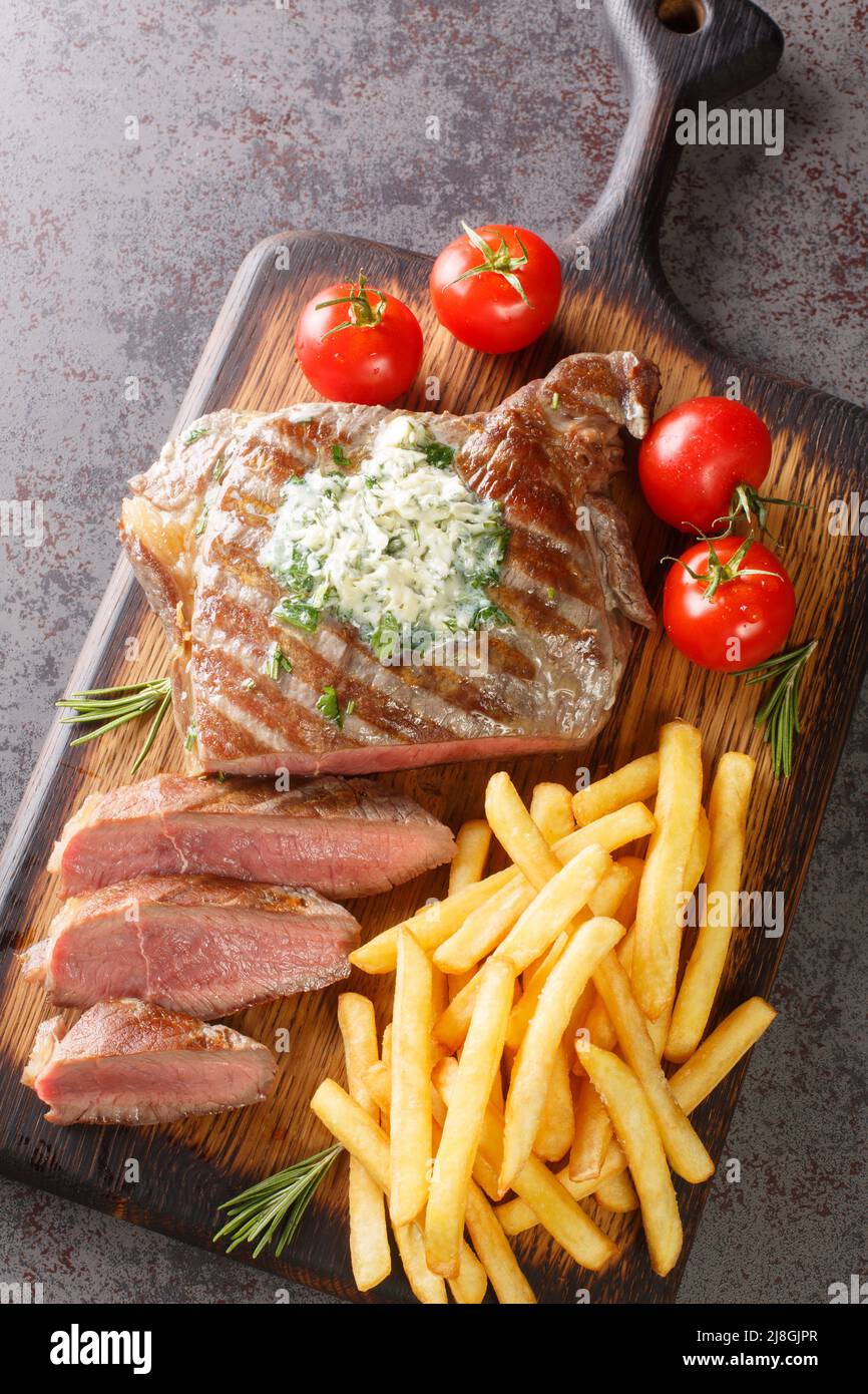 Delicious grilled steak frites with French fries and green butter