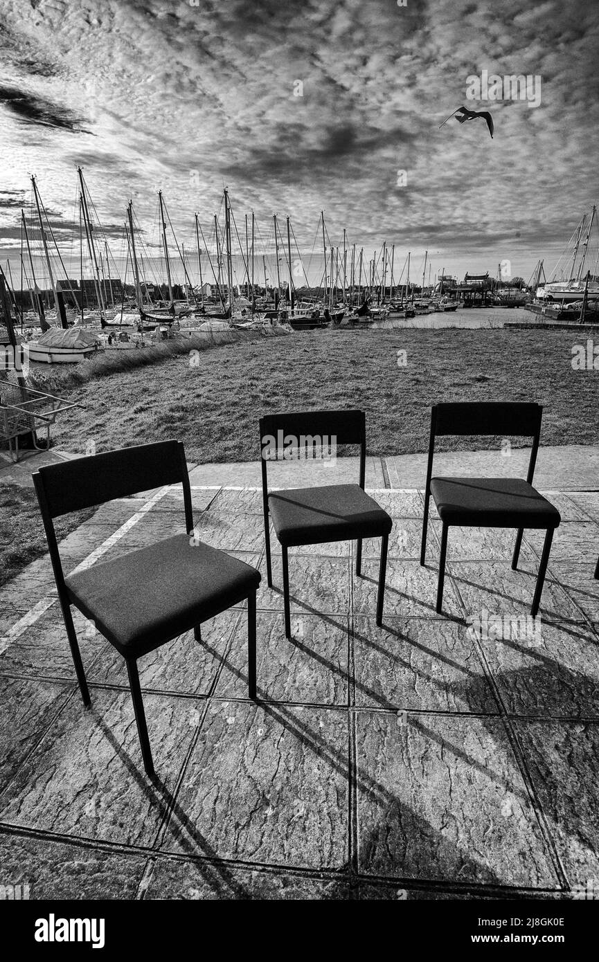 empty chairs in semicircle at boat yard Stock Photo