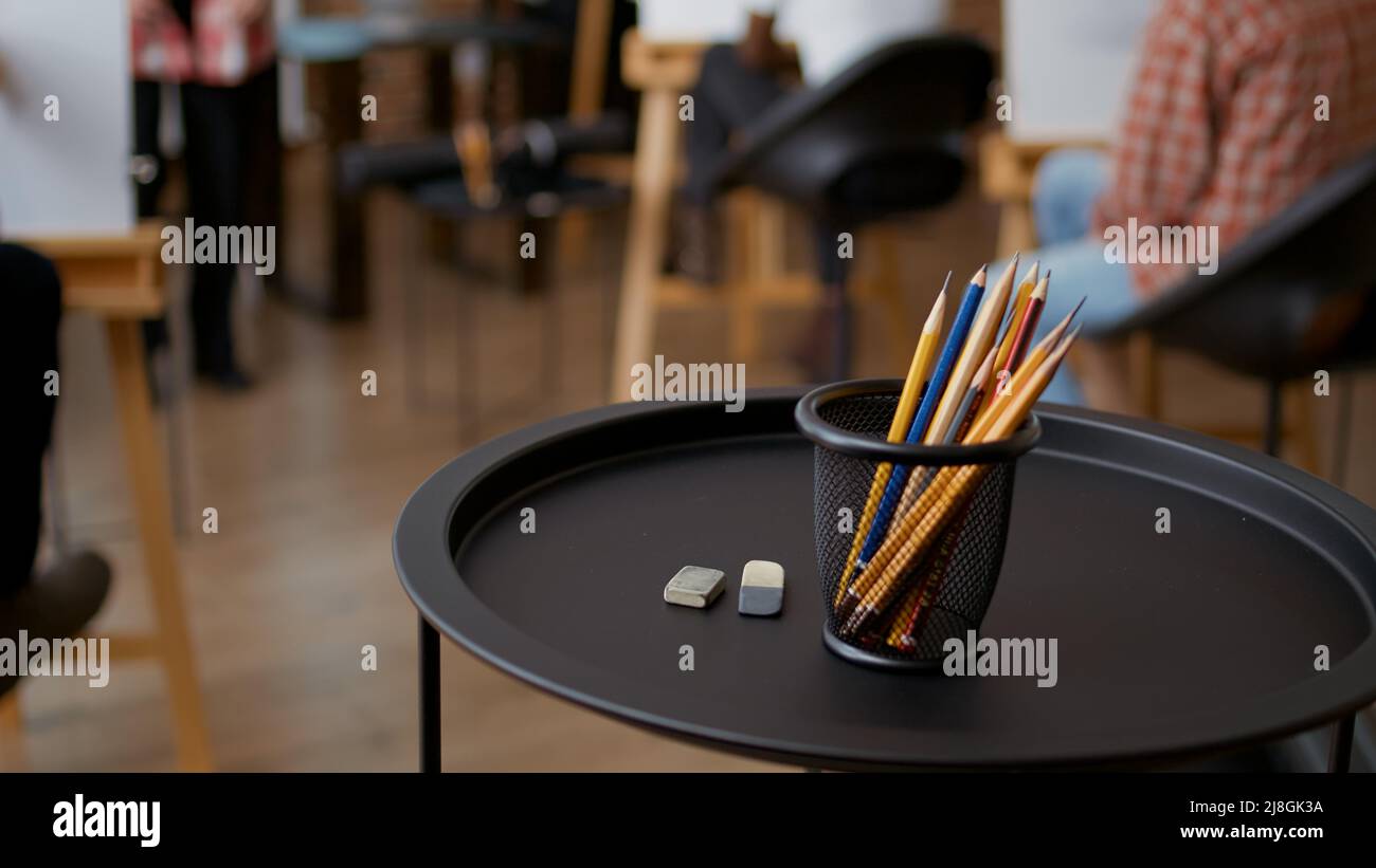Colorful pencils and erasers on table in art class studio, to practice