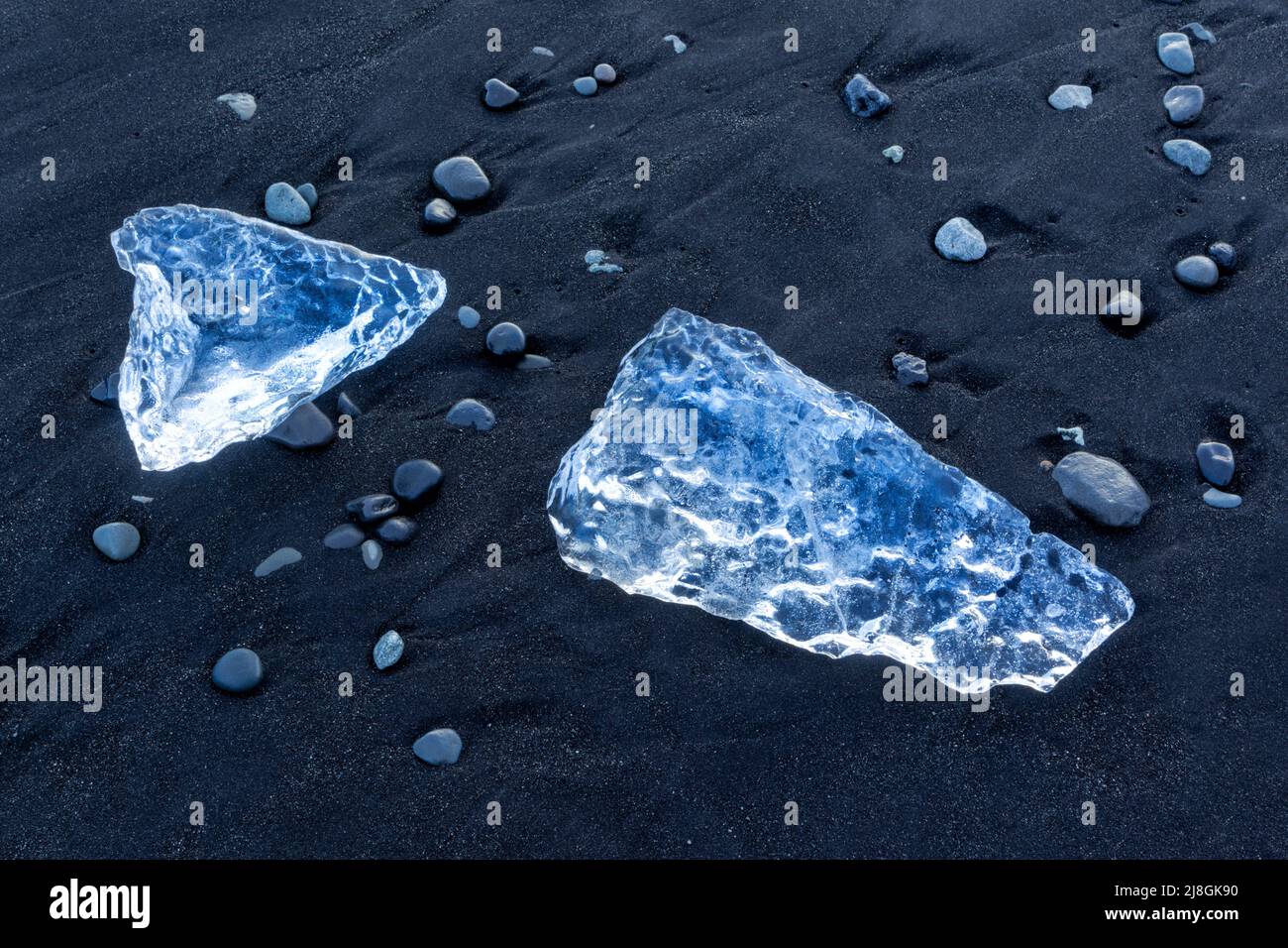 Iceberg fragments washed up on the beach at Jökulsarlön where icebergs flow out of Jökulsarlön lagoon in Iceland.  Sometimes called diamond beach. Stock Photo