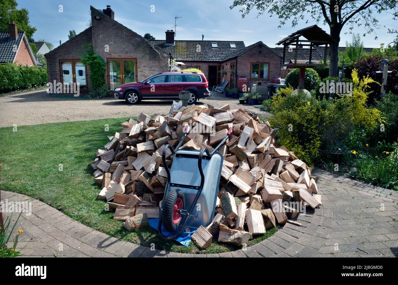 freshly delivered pile of logs  outside rural bungalow norfolk england Stock Photo