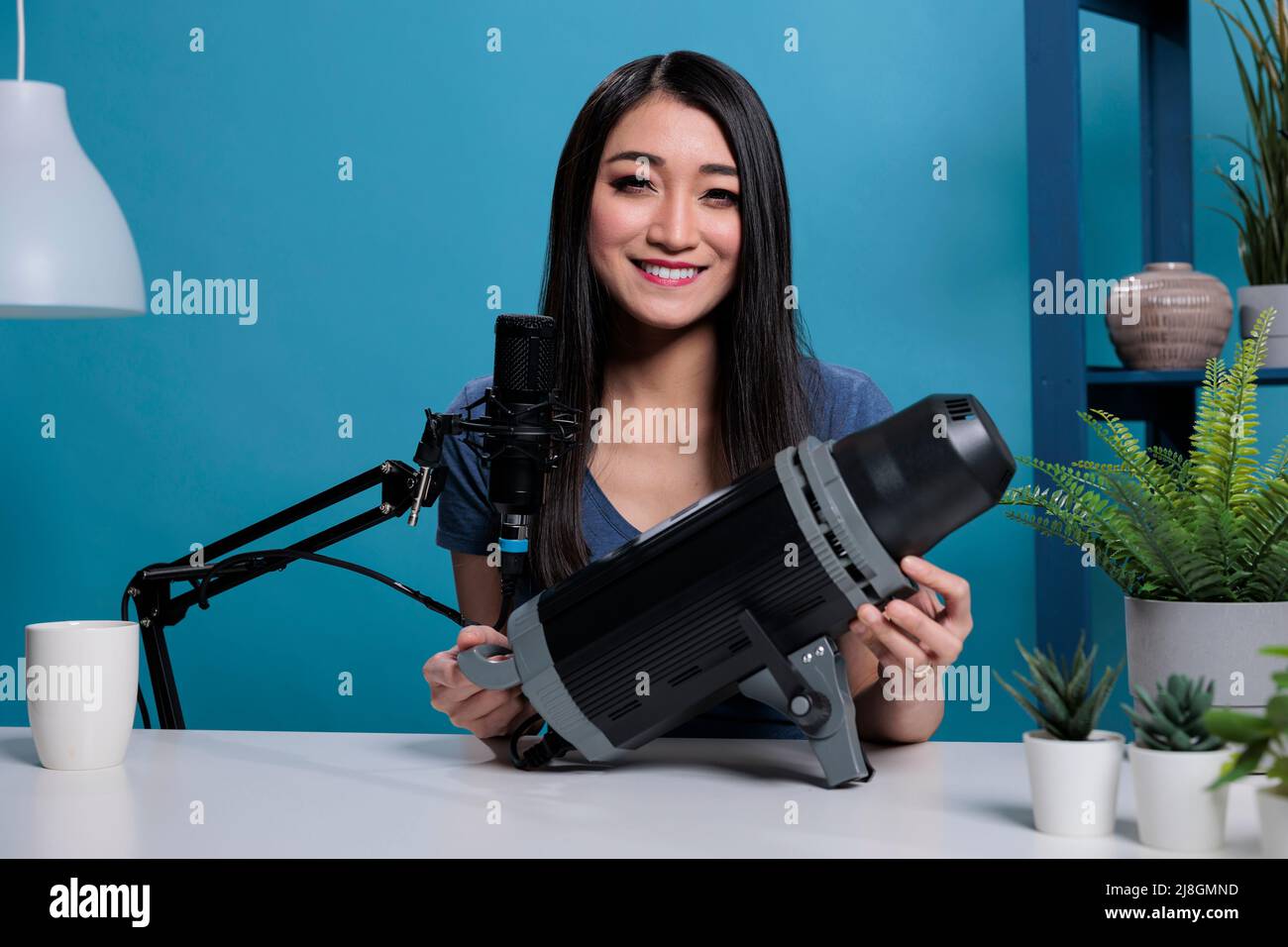 Social media blogger showing studio light on camera reviewing videoblog