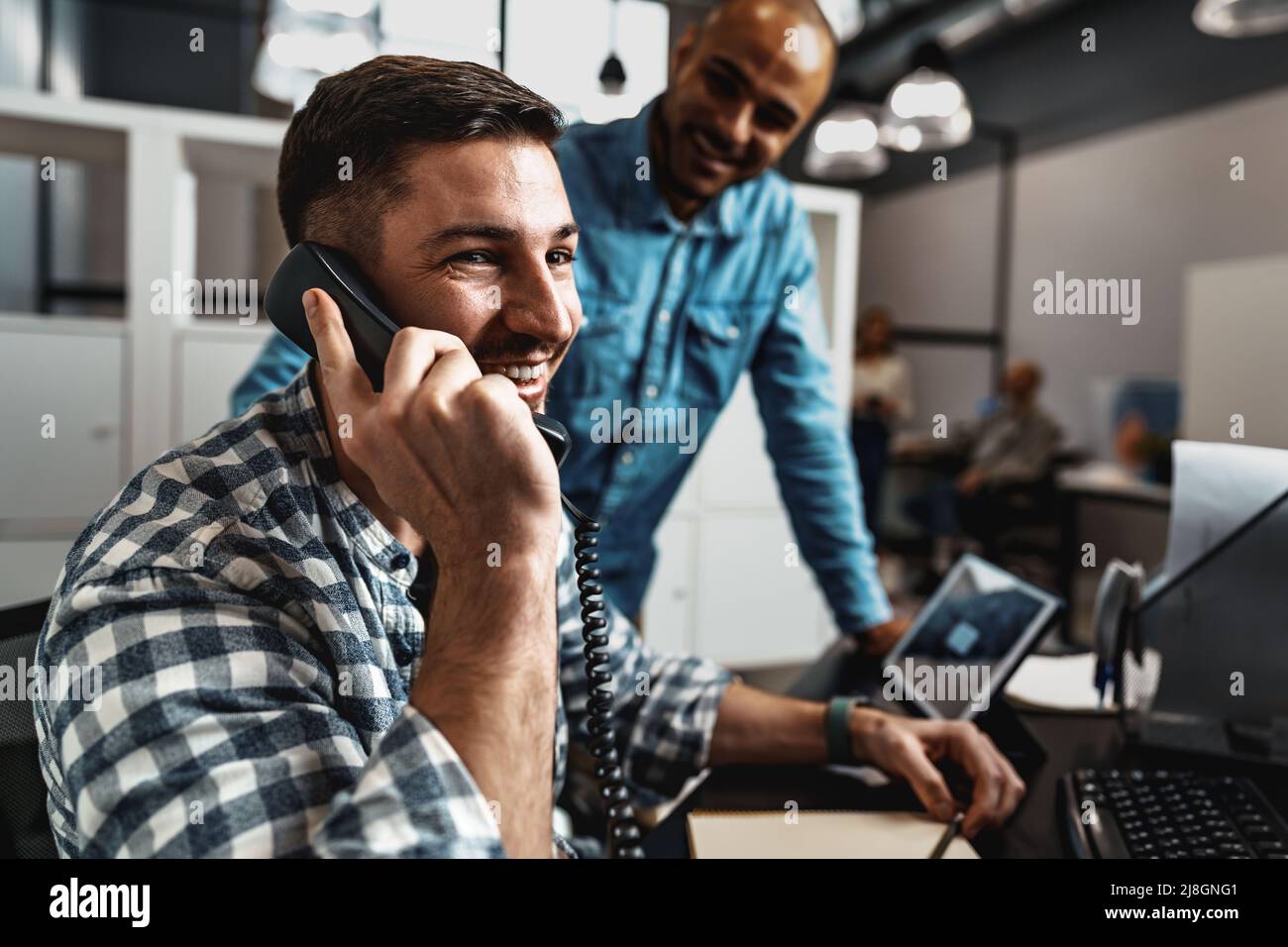 Two young men working together on a new business project in office ...