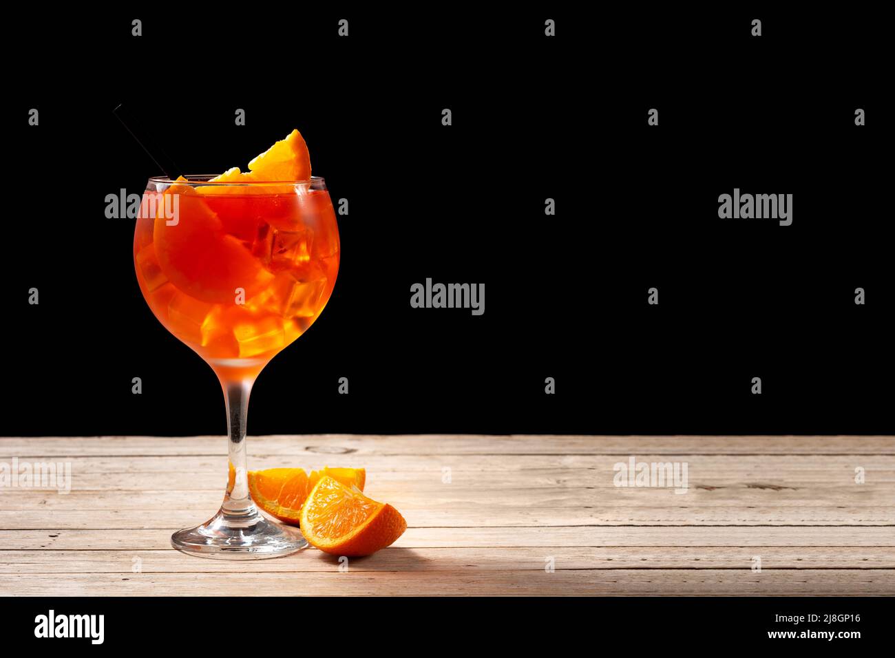 Glass of aperol spritz cocktail on wooden table Stock Photo