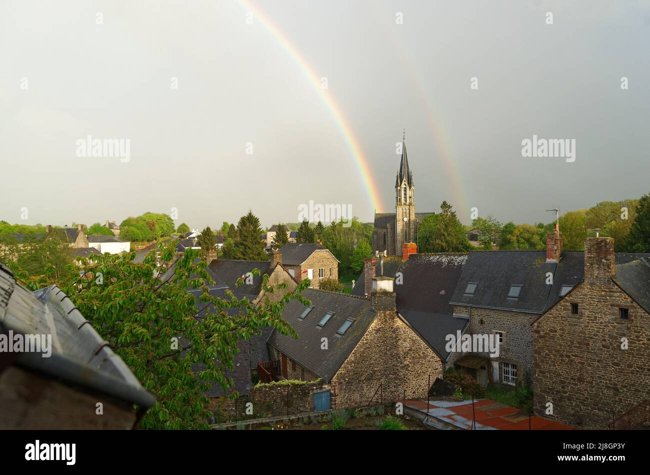 Rainbow over a village in North-West France (Le Pas, Mayenne, Loire country) Stock Photo