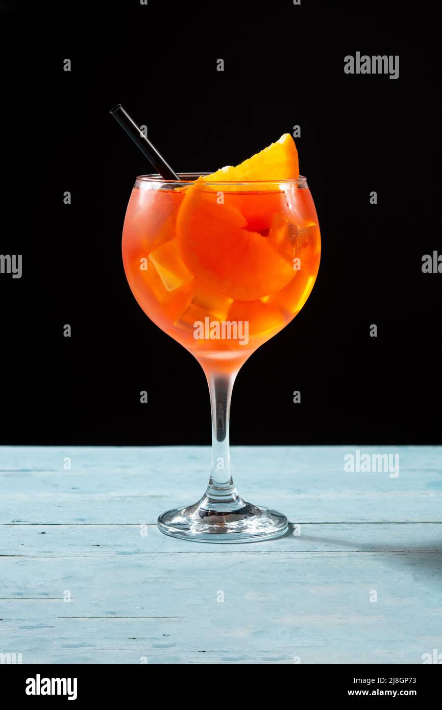 Glass of aperol spritz cocktail on blue wooden table Stock Photo