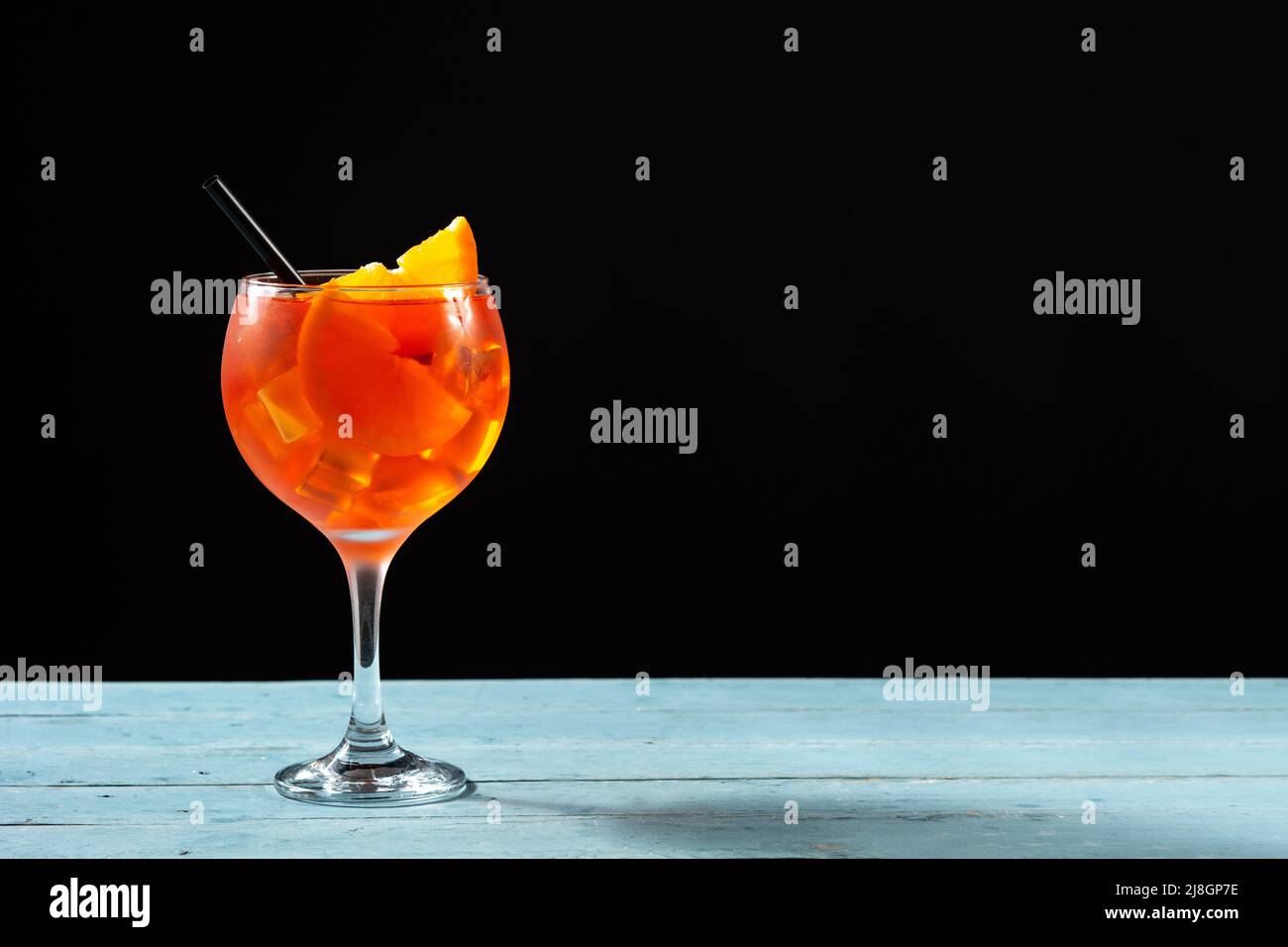 Glass of aperol spritz cocktail on blue wooden table Stock Photo