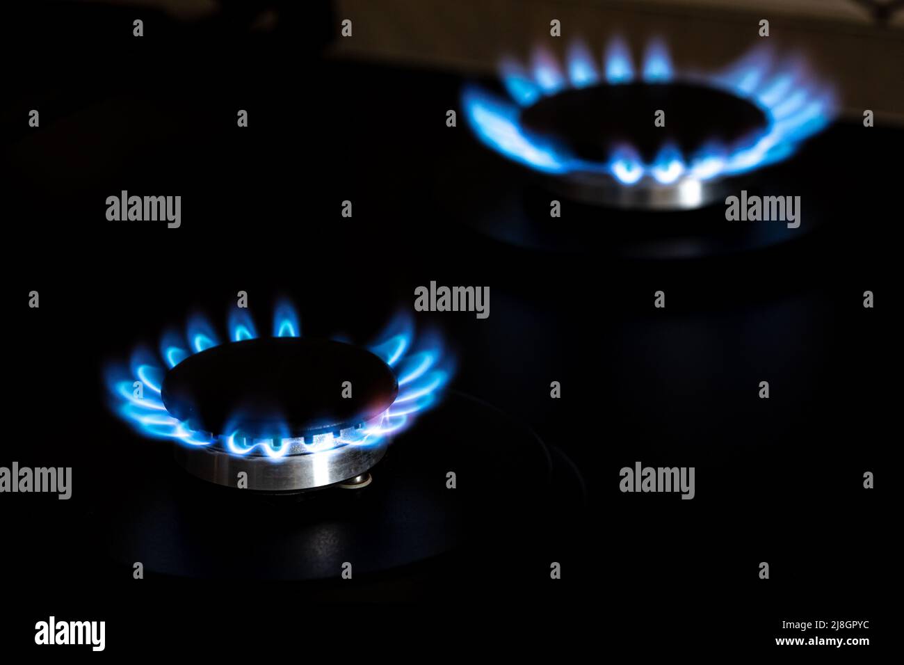 https://c8.alamy.com/comp/2J8GPYC/closeup-shot-of-blue-fire-from-domestic-kitchen-stove-top-burning-gas-gas-stove-burner-gas-cooker-with-burning-flames-of-propane-gas-industrial-re-2J8GPYC.jpg