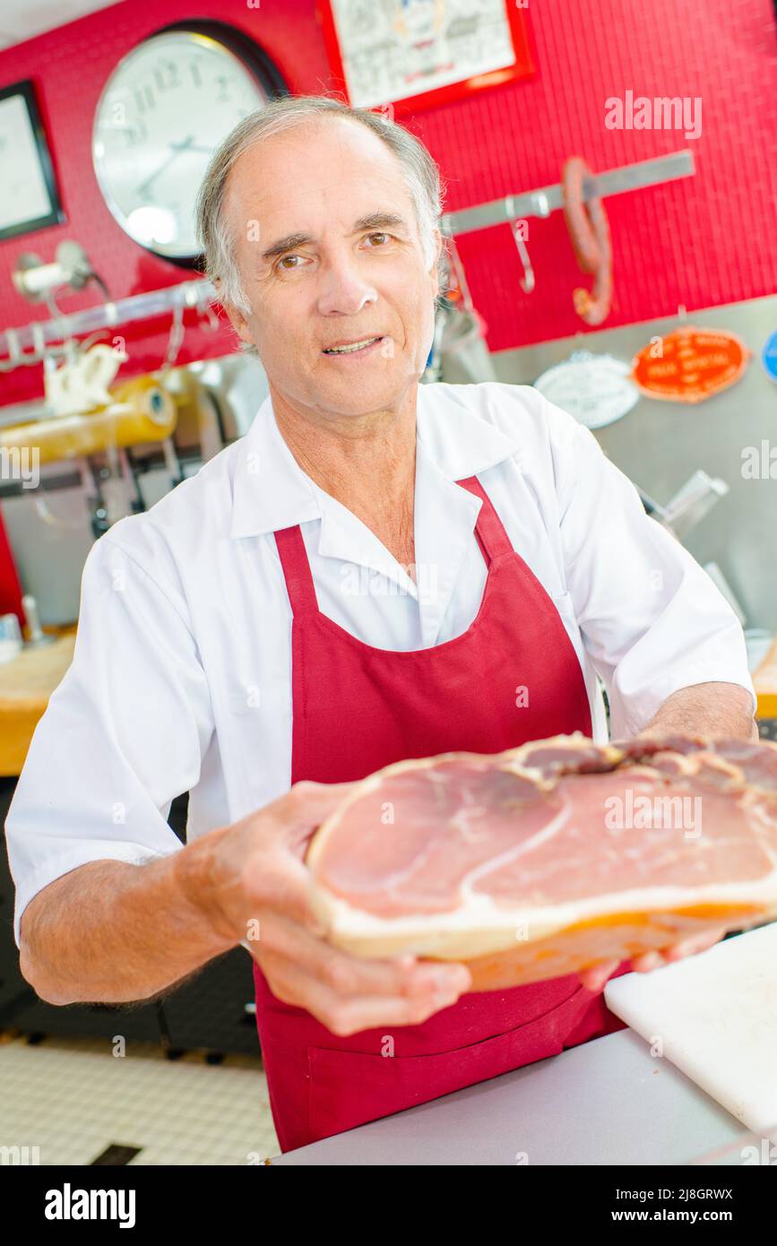 a butcher holding cured ham Stock Photo Alamy