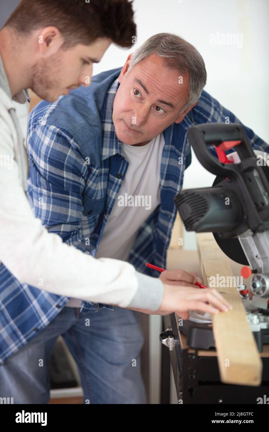 apprentice learning how to cut wood with a circular saw Stock Photo Alamy