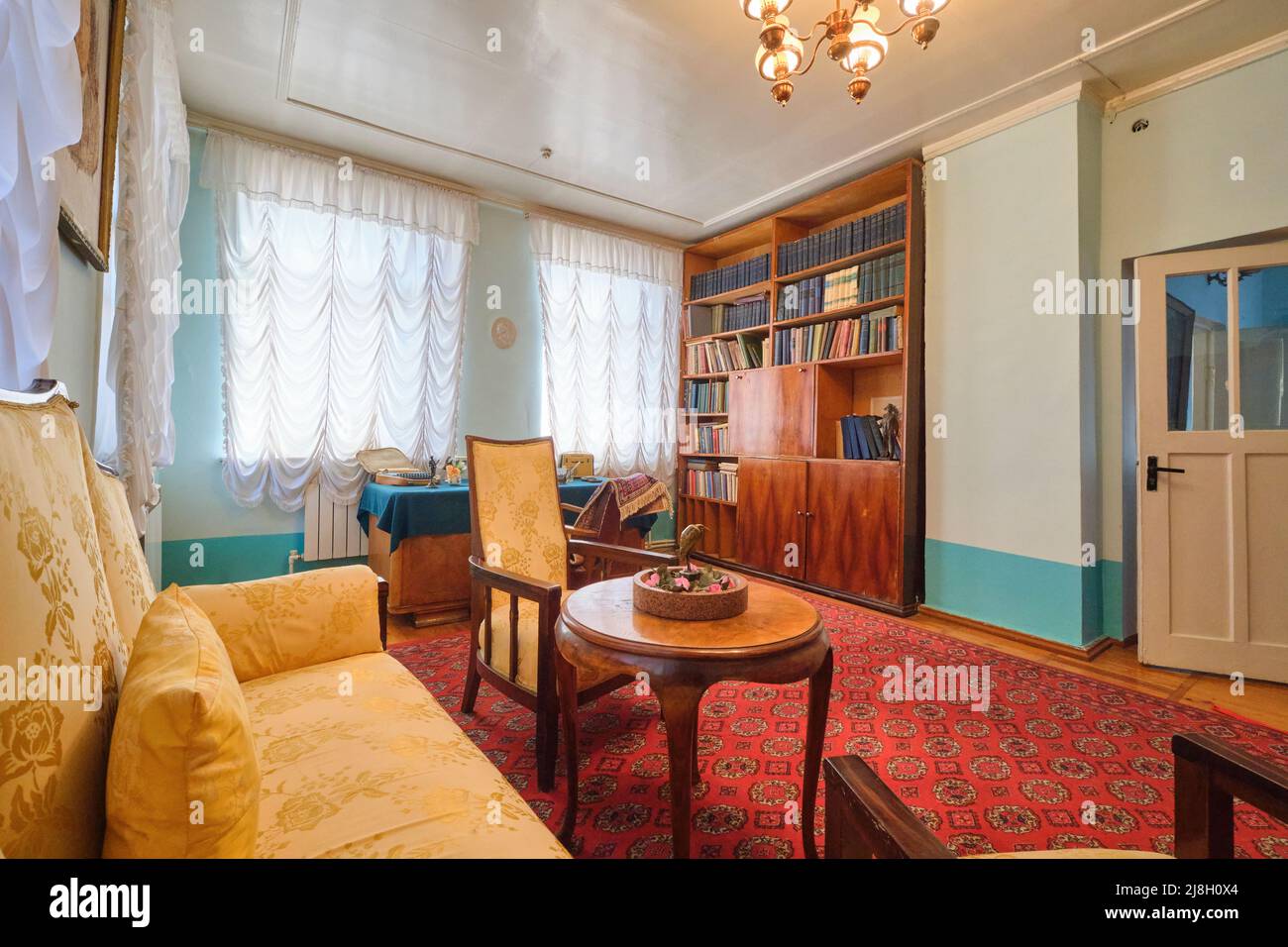 A sitting room with writing desk and yellow sofa. At writer, poet ...