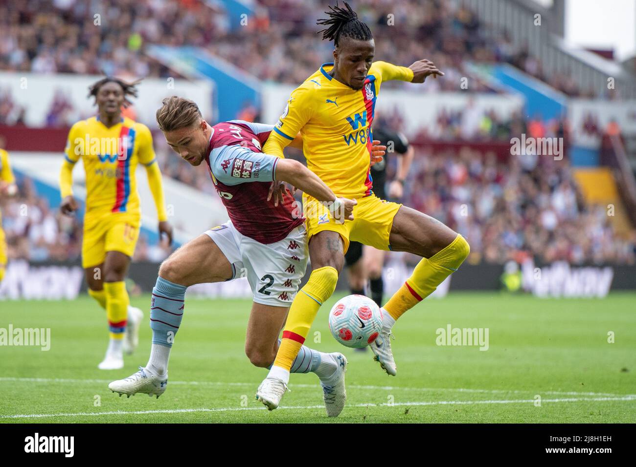 BIRMINGHAM, ENGLAND - MAY 15: Matty Cash of Aston Villa and Wilfried Zaha of Crystal Palace in action during the Premier League match between Aston Vi Stock Photo