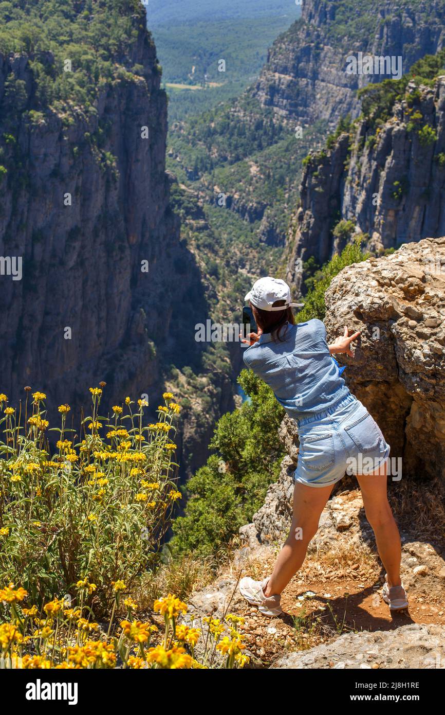 Tazi Canyon landscape in Manavgat Turkey. happy girl take a photo on the steep slope. valley and cliff Stock Photo