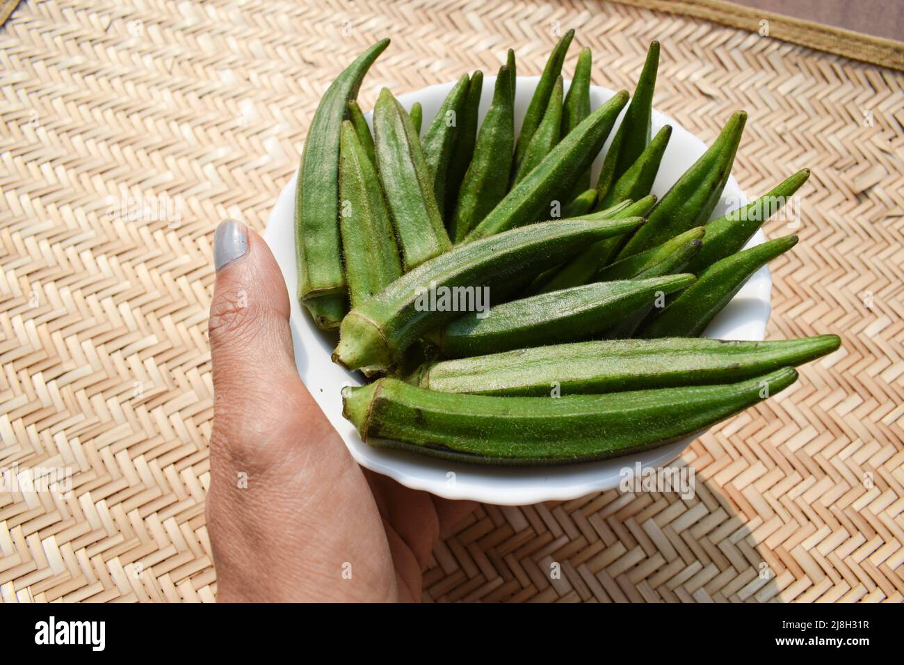 Female holding Fresh Okra vegetable or Green vegetables Lady finger or