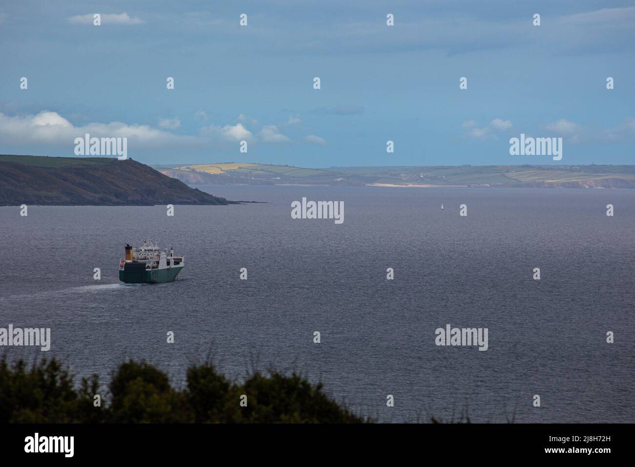 A ship leaves Plymouth in the English Channel, view from Rame head Peninsula Stock Photo
