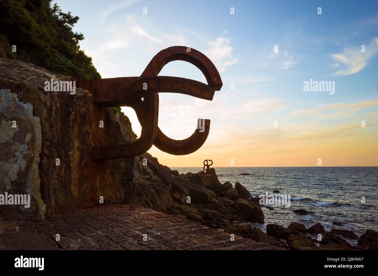 Donostia, Gipuzkoa, Basque Country, Spain - July 15th, 2019 : View at sunset of The comb of the wind (Peine del viento/Haizearen orrazia) sculpture of Stock Photo