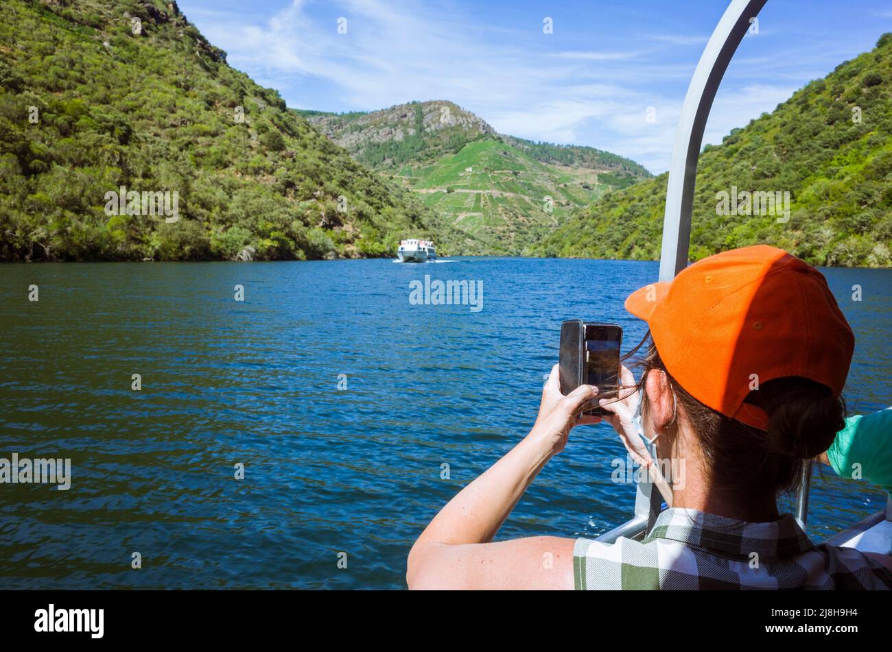 River Sil canyon, Ourense, Galicia, Spain: A woman takes pictures from a ferry boat on the river Sil canyon. Stock Photo