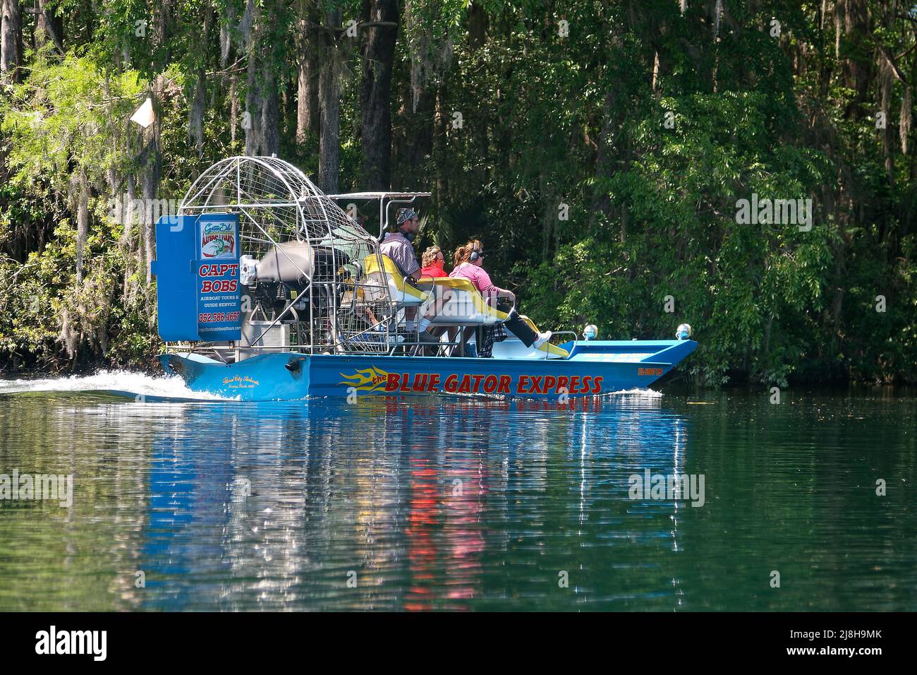 airboat moving; 4 people, motion, tour, business, noisy, earphones, transportation; Rainbow River; Florida; Dunnellon; FL; spring Stock Photo