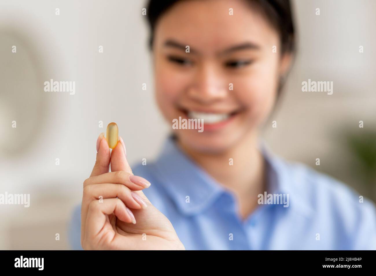 Selective focus on gelatine capsule in asian woman hand Stock Photo Alamy