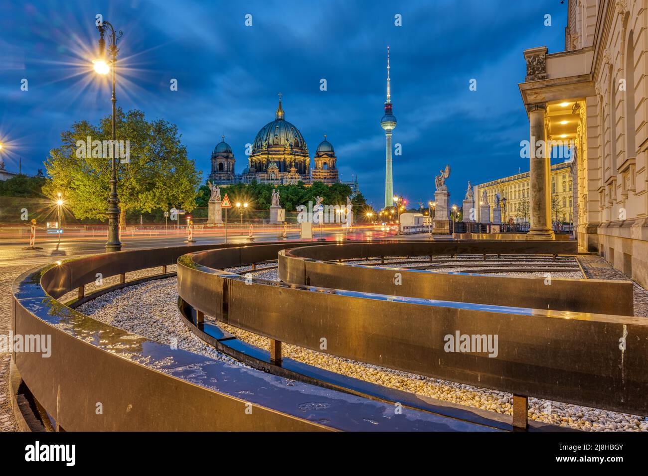 View of Unter den Linden boulevard in Berlin at night with the TV Tower and the cathedral in the back Stock Photo