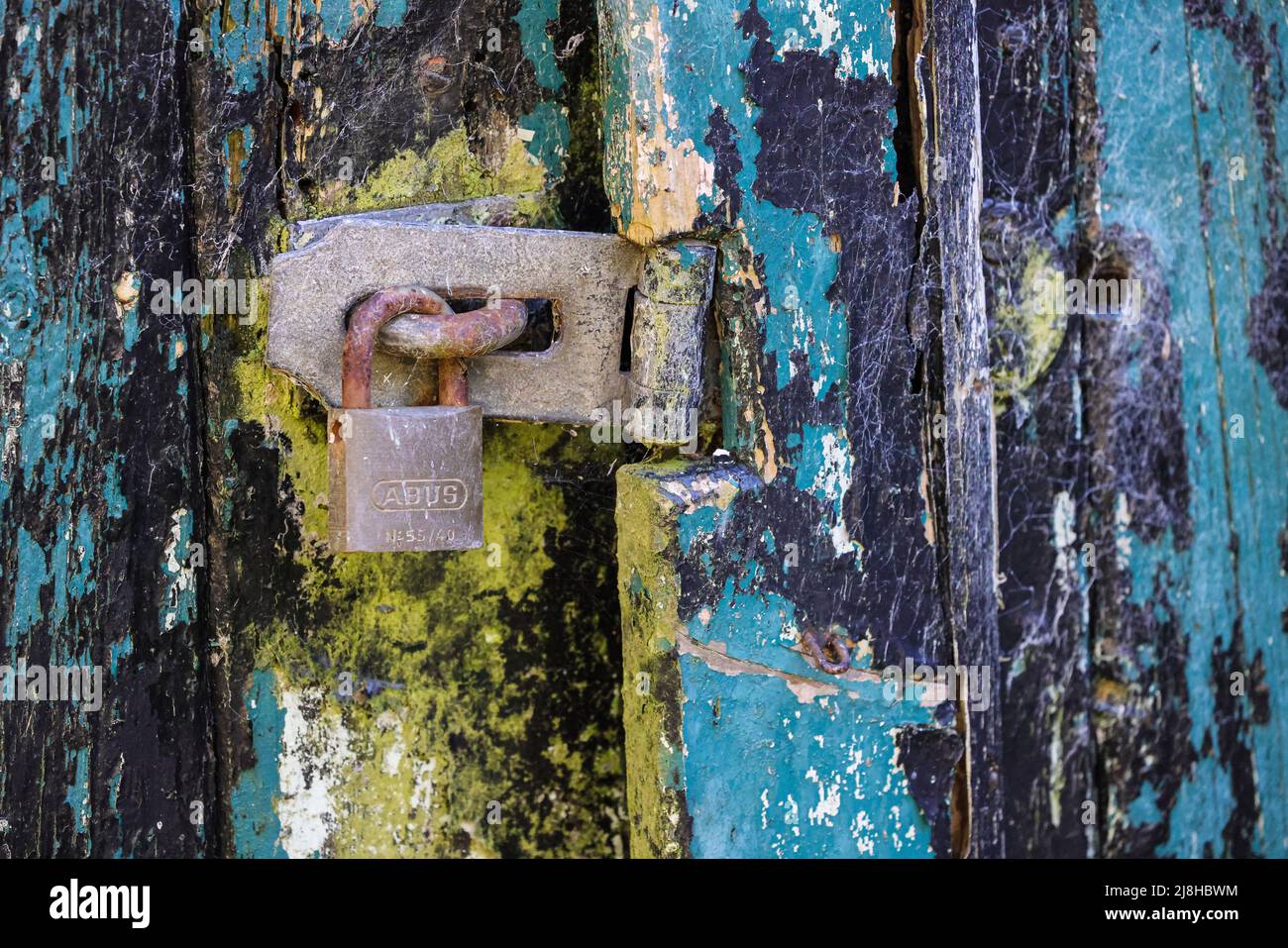 Old padlocked door latch Stock Photo