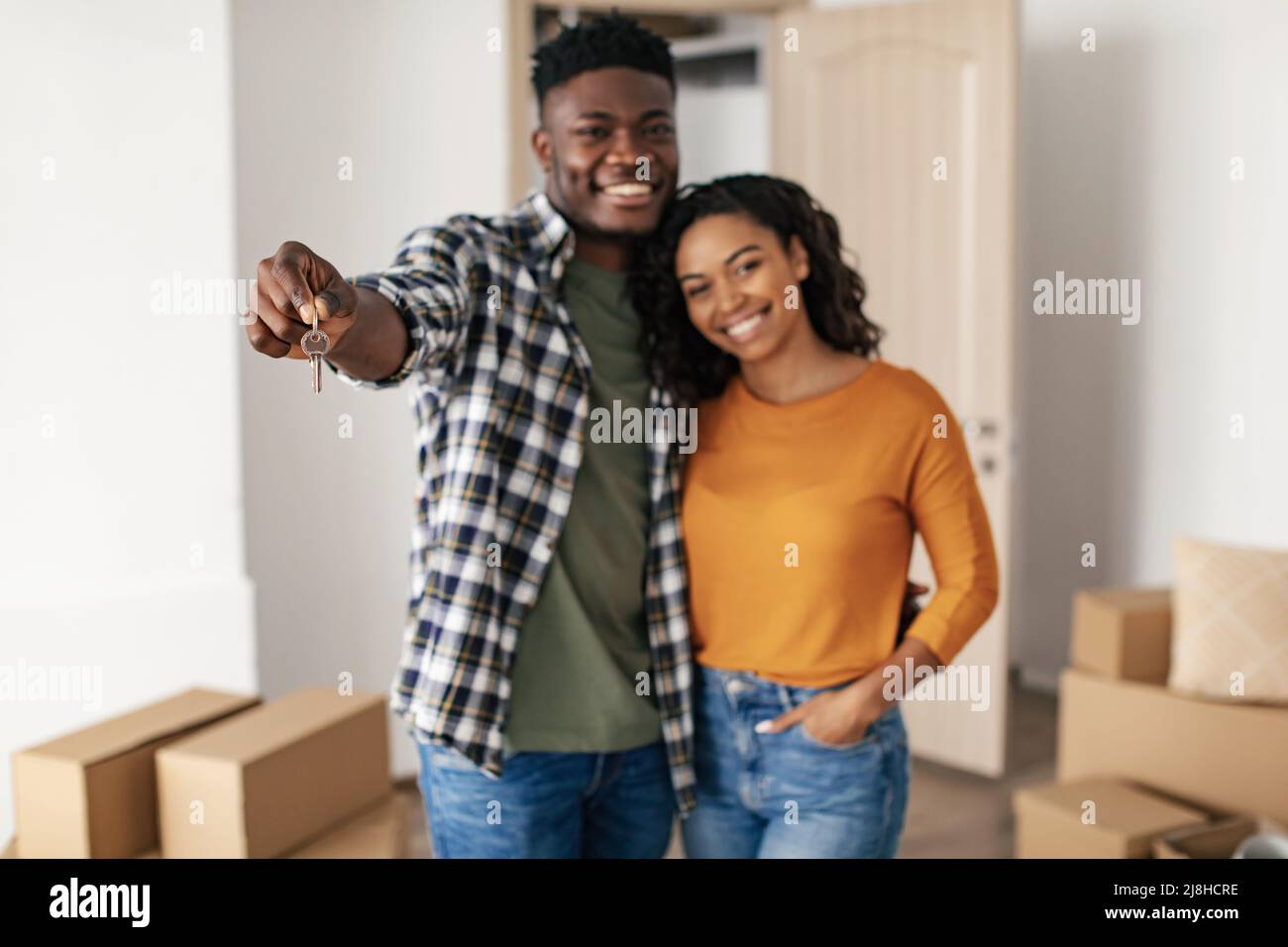 Happy Black Couple Showing New House Key Embracing At Home Stock Photo ...