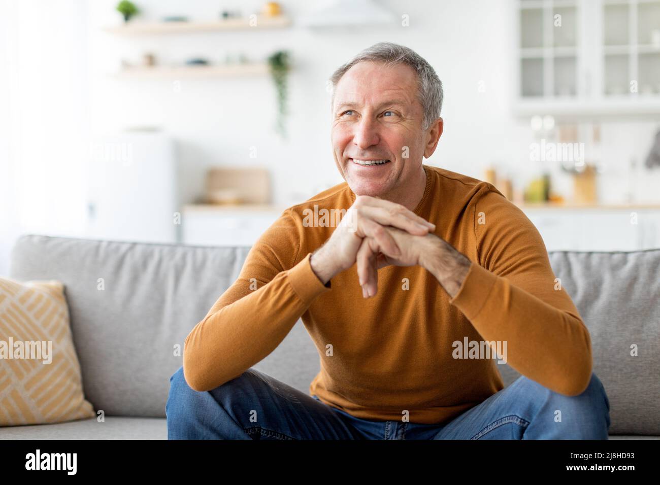 Man sitting on couch thinking hi-res stock photography and images - Alamy