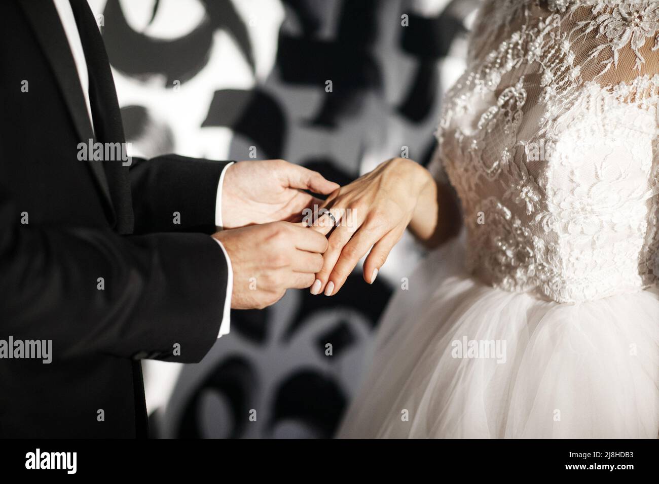 The groom wears a ring to the bride at the wedding ceremony Stock Photo ...