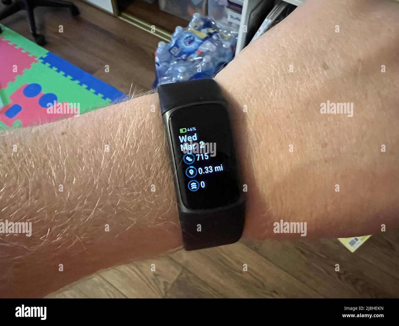 Person's arm with Fitbit Charge 5 fitness tracker visible, Lafayette, California, March 2, 2022
