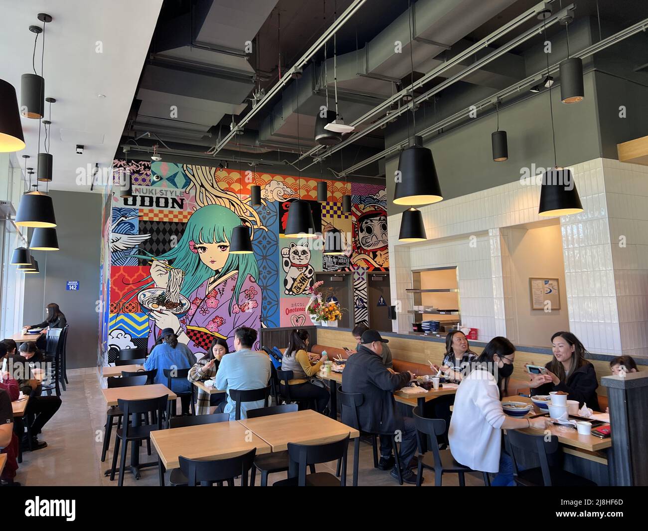 Interior with diners during grand opening of Marugame Udon at City