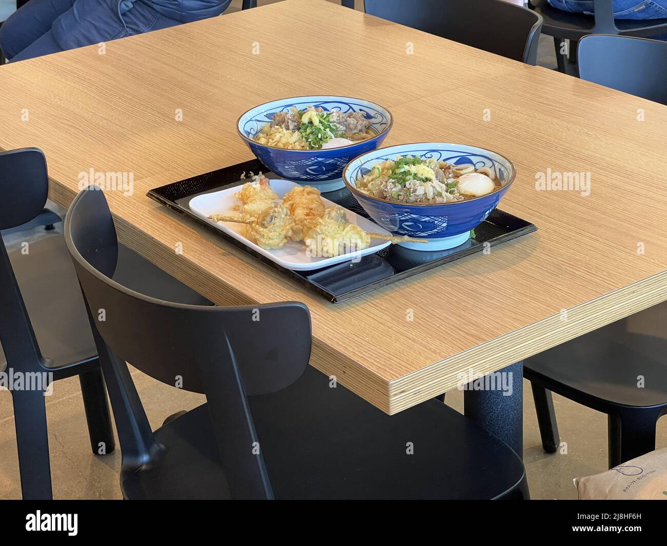 Udon soup is arranged at a table during grand opening of Marugame Udon