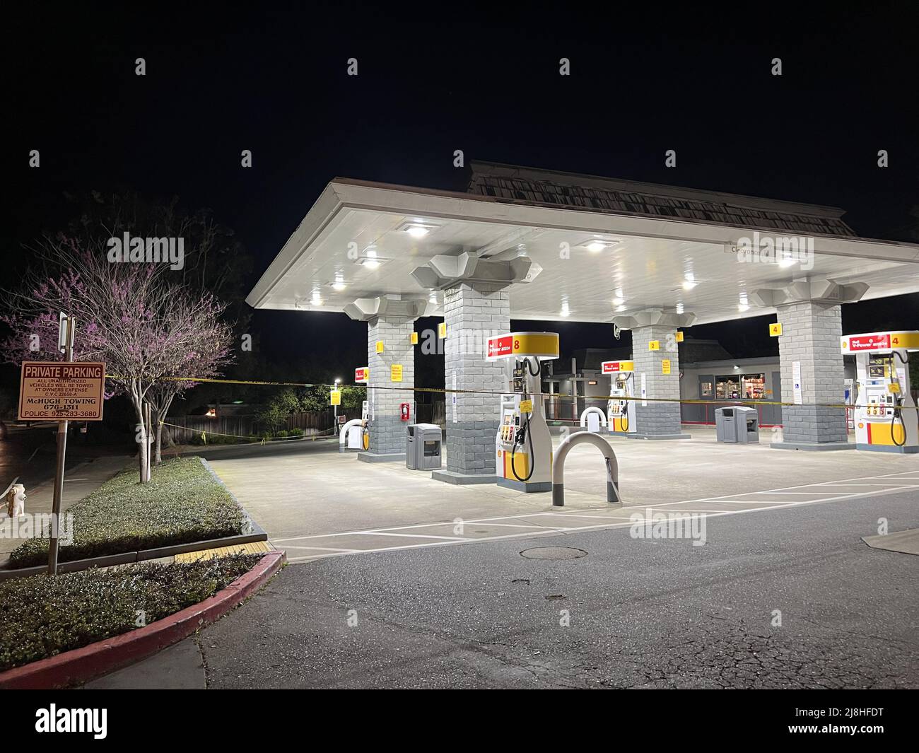At night, a gas station in Lafayette, California is closed and roped off with caution tape, March 22, 2022. Photo courtesy Sftm. Stock Photo