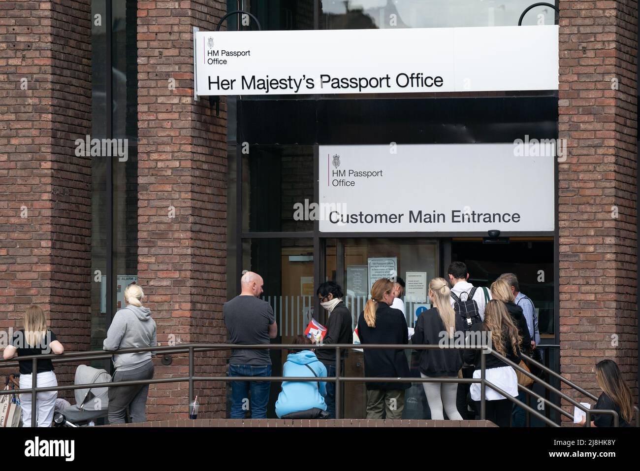 People queuing outside the passport office in Peterborough, as thousands of Brits face the prospect of lengthy delays for passport applications due to a combination of staff shortages and a surge in post-Covid travel. Picture date: Monday May 16, 2022. Stock Photo