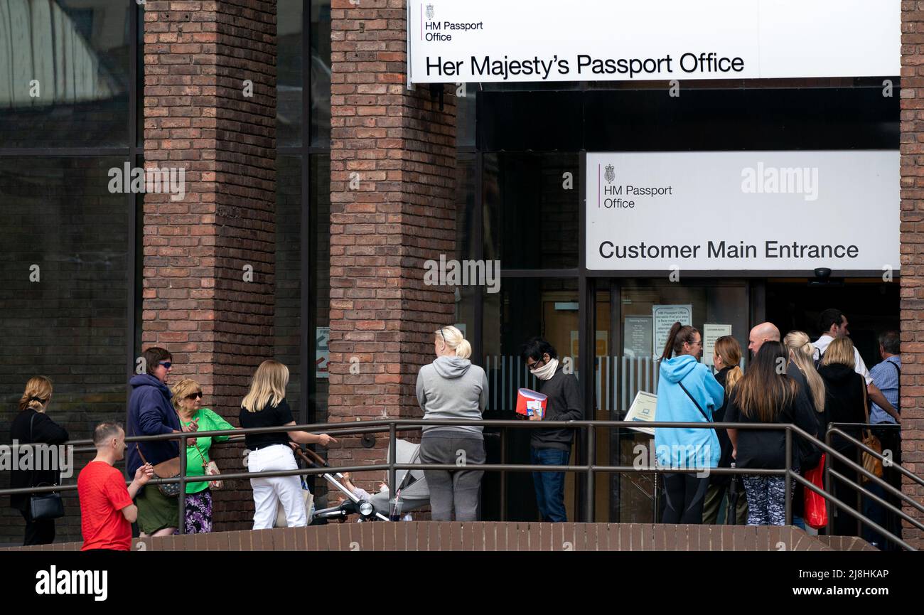 People queuing outside the passport office in Peterborough, as thousands of Brits face the prospect of lengthy delays for passport applications due to a combination of staff shortages and a surge in post-Covid travel. Picture date: Monday May 16, 2022. Stock Photo