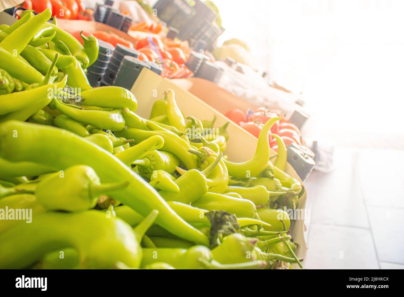 Fresh vegetables in the grocery store stall with sunlight, copy space bokeh background. Bunch of market stalls, selective focus close-up. Stock Photo
