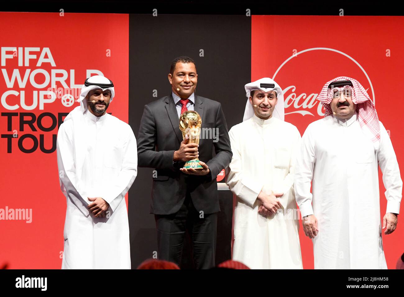 Kuwait City. 16th May, 2022. Brazilian former soccer player Gilberto Silva (2nd L) displays the World Cup trophy during a FIFA World Cup Trophy Tour event in Kuwait City, Kuwait, May 16, 2022. Credit: Xinhua/Alamy Live News Stock Photo