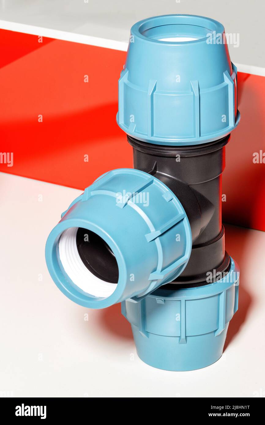 Connecting triple fitting for pvc pipe. Vertical image. Closeup Stock