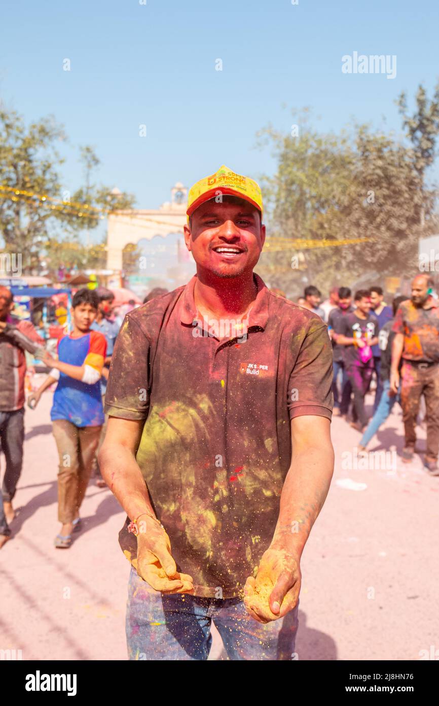Barsana, Uttar Pradesh, India - March 2022: Portrait on Indian people with color on face celebrating the colorful holi festival on the streets. Stock Photo