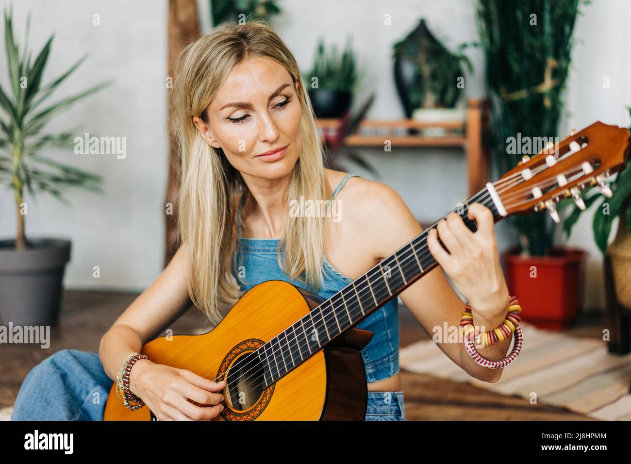 Portrait of romantic woman playing acoustic guitar Stock Photo