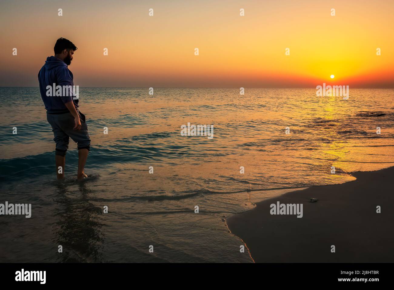 An young man standing at RAS TANURA Beach. Al Jubail, Saudi Arabia. Stock Photo