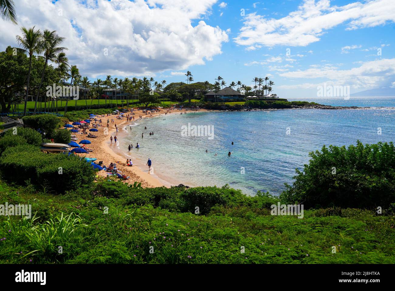 Tourists relaxing on the beach of Kapalua Bay on West Maui, Hawaii, during Spring Break Stock